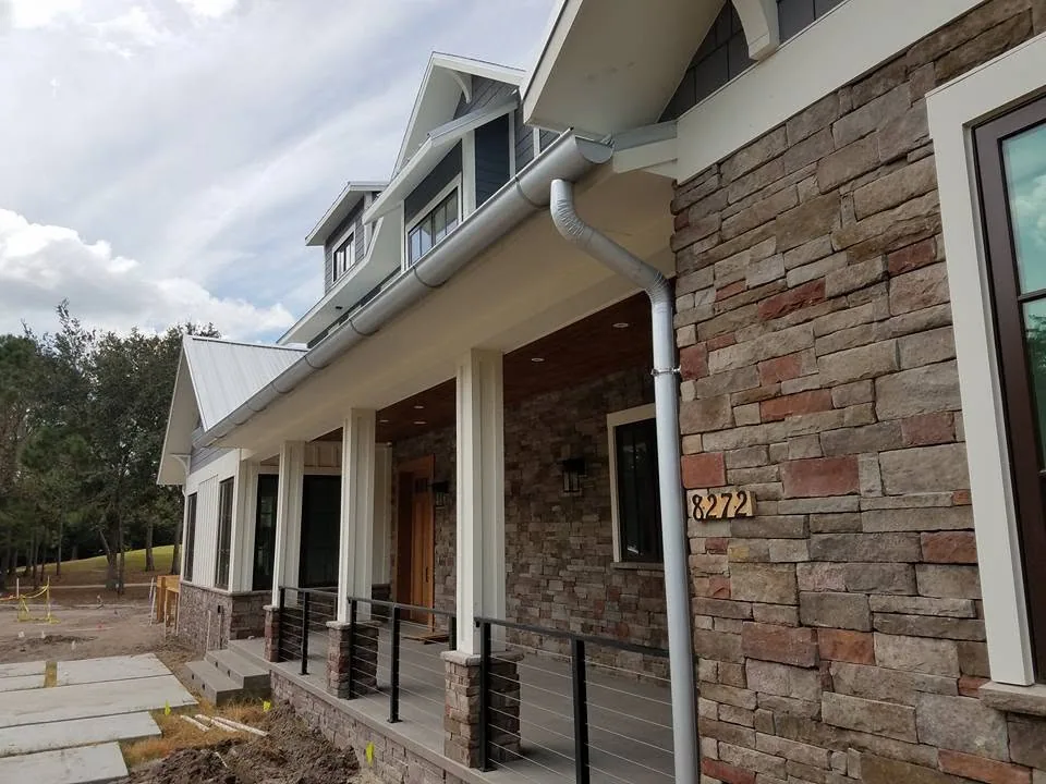 Stone veneer porch cable railing galvalume gutter, Sanford